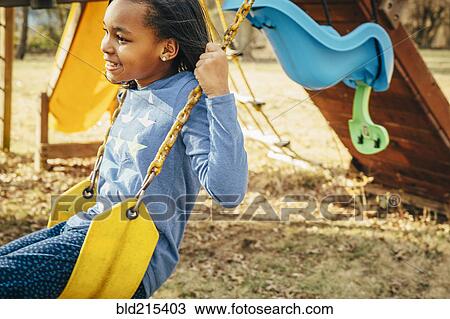 Black girl sitting on swing set View Large Photo Image Stock Image - Black girl sitting on swing set. Fotosearch
