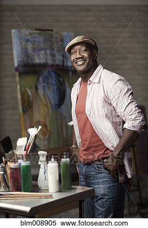 Black man standing in artist's studio View Large Photo Image Stock Photography - Black man standing in artist's studio. Fotosearch