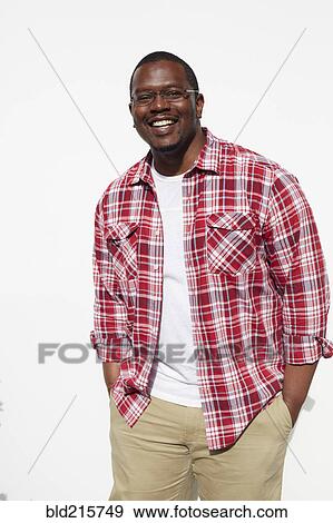 Stock Photo - Black man standing with hands in pockets. Fotosearch