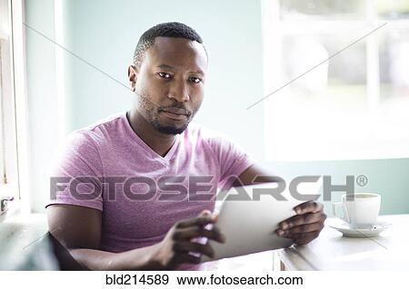 Black man using digital tablet View Large Photo Image Stock Photo - Black man using digital tablet. Fotosearch