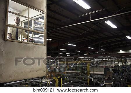 Black manager in factory office looking out View Large Photo Image Stock Image - Black manager in factory office looking out. Fotosearch