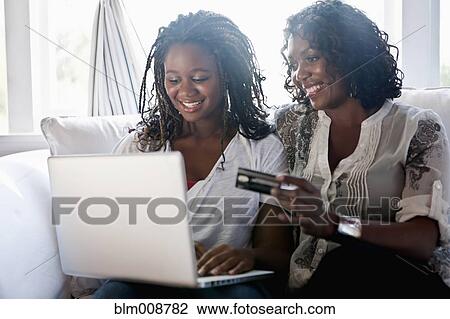 Black mother and daughter shopping online with credit card View Large Photo Image Stock Image - Black mother and daughter shopping online with credit card. Fotosearch