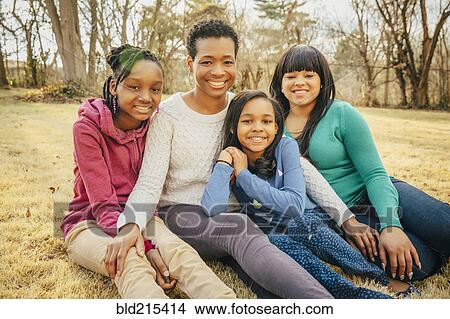Black mother and daughters sitting outdoors View Large Photo Image Picture - Black mother and daughters sitting outdoors. Fotosearch
