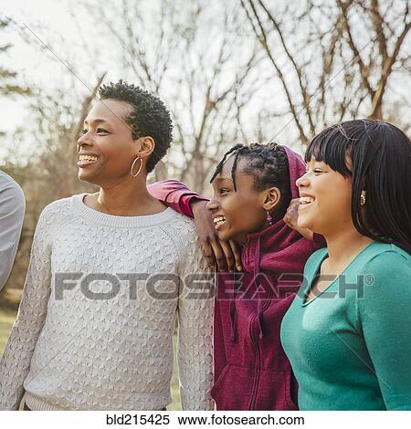 Stock Photography - Black mother and daughters smiling outdoors. Fotosearch