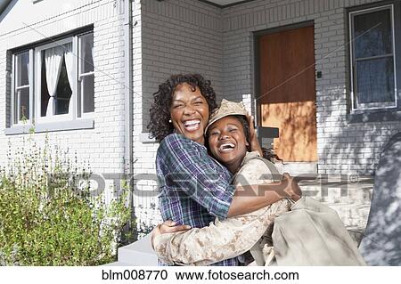 Black mother hugging soldier daughter View Large Photo Image Stock Image - Black mother hugging soldier daughter. Fotosearch