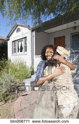 Black mother hugging soldier daughter View Large Photo Image Stock Image - Black mother hugging soldier daughter. Fotosearch