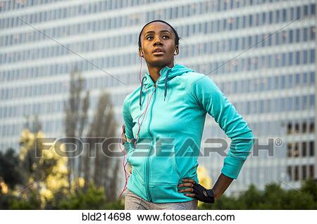 Black runner standing near high rise building View Large Photo Image Stock Photo - Black runner standing near high rise building. Fotosearch