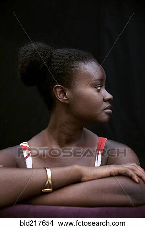 Picture - Black woman leaning on forearms. Fotosearch