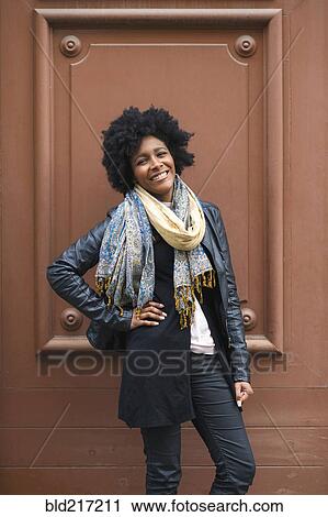 Black woman smiling near frame in wall View Large Photo Image Stock Image - Black woman smiling near frame in wall. Fotosearch