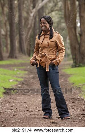 Black woman standing on dirt path View Large Photo Image Picture - Black woman standing on dirt path. Fotosearch