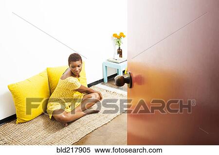 Stock Photography - Black woman stretching on floor. Fotosearch