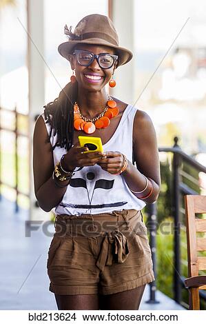 Black woman using cell phone outdoors View Large Photo Image Picture - Black woman using cell phone outdoors. Fotosearch