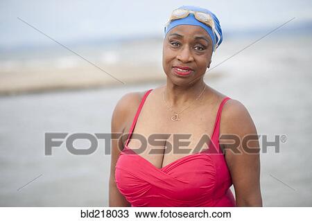Stock Image - Black woman wearing swimsuit and goggles. Fotosearch