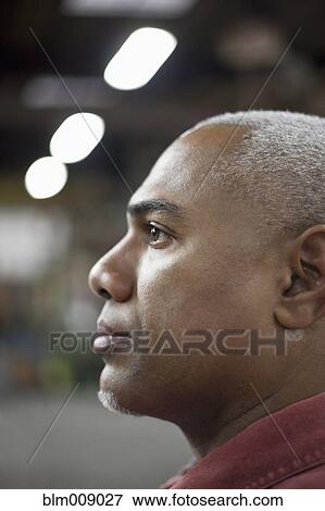 Black worker standing in factory View Large Photo Image Stock Photo - Black worker standing in factory. Fotosearch