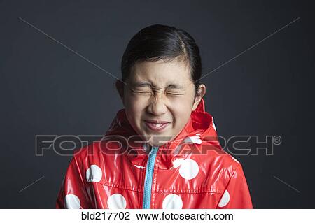 Blinking Asian girl wearing raincoat View Large Photo Image Stock Image - Blinking Asian girl wearing raincoat. Fotosearch