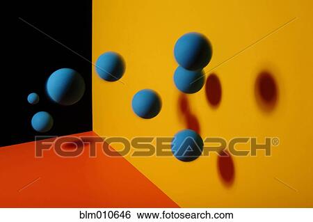 Blue balls bouncing on orange surface against yellow wall View Large Photo Image Stock Photograph - Blue balls bouncing on orange surface against yellow wall. Fotosearch