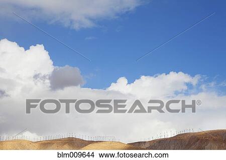 Picture - Blue sky and wind farm on hilltop. Fotosearch
