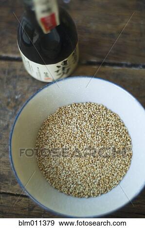 Bottle of sake and bowl of sesame seeds View Large Photo Image Stock Photo - Bottle of sake and bowl of sesame seeds. Fotosearch
