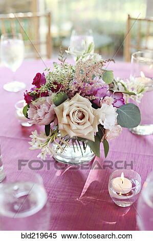 Stock Photography - Bouquet of flowers in vase on pink tablecloth. Fotosearch