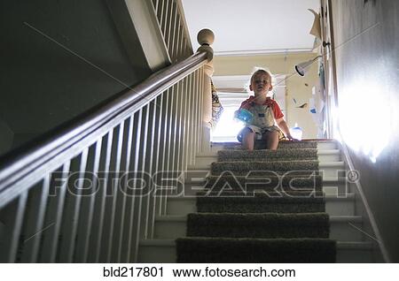 Boy playing at top of staircase View Large Photo Image Stock Image - Boy playing at top of staircase. Fotosearch