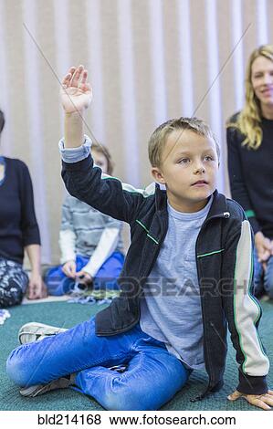 Boy raising hand in classroom View Large Photo Image Stock Photo - Boy raising hand in classroom. Fotosearch