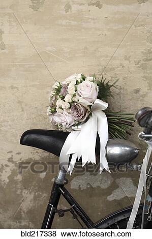 Stock Photo - Bridal bouquet on seat of bicycle. Fotosearch