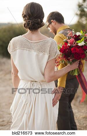 Bride and groom walking on rural hilltop View Large Photo Image Stock Image - Bride and groom walking on rural hilltop. Fotosearch