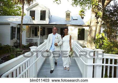 Bride and groom walking together after wedding View Large Photo Image Stock Image - Bride and groom walking together after wedding. Fotosearch