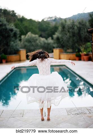 Bride diving into swimming pool View Large Photo Image Stock Photo - Bride diving into swimming pool. Fotosearch