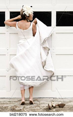 Bride peeking inside garage window View Large Photo Image Stock Photography - Bride peeking inside garage window. Fotosearch