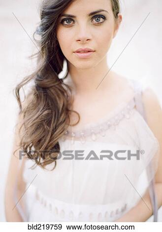 Stock Photo - Bride with curled hair in wedding dress. Fotosearch