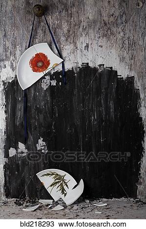Broken plate hanging from string on wall View Large Photo Image Stock Image - Broken plate hanging from string on wall. Fotosearch