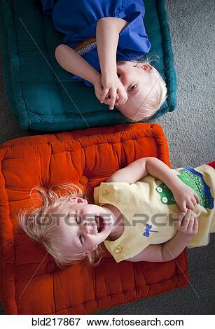 Brother and sister playing on cushions on floor View Large Photo Image Stock Photo - Brother and sister playing on cushions on floor. Fotosearch