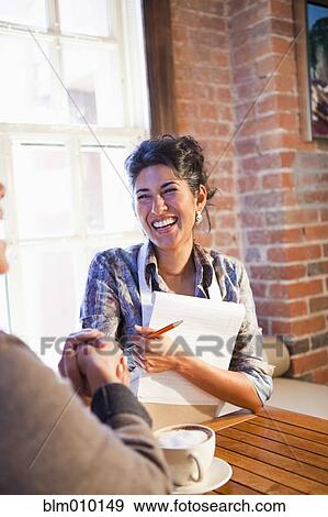 Business owner shaking hands with customer in cafe View Large Photo Image Stock Photo - Business owner shaking hands with customer in cafe. Fotosearch
