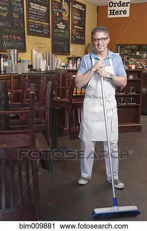 Business owner sweeping cafe floor View Large Photo Image Stock Image - Business owner sweeping cafe floor. Fotosearch
