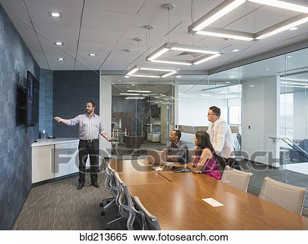 Stock Photography - Business people having meeting in conference room. Fotosearch