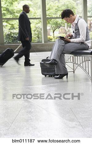 Business people in office lobby View Large Photo Image Stock Photo - Business people in office lobby. Fotosearch