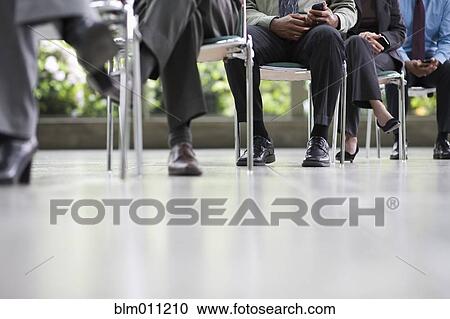 Business people sitting in chairs together View Large Photo Image Stock Image - Business people sitting in chairs together. Fotosearch