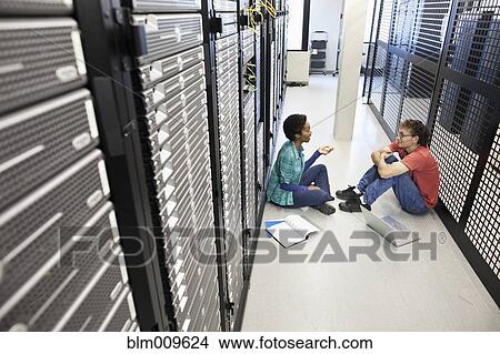 Business people sitting on floor and talking in office technology room View Large Photo Image Picture - Business people sitting on floor and talking in office technology room. Fotosearch