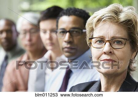 Stock Image - Business people standing together. Fotosearch