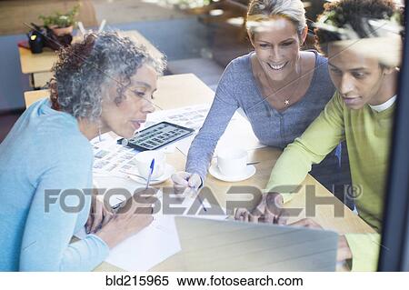 Stock Photography - Business people using laptop in office meeting. Fotosearch