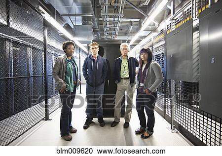 Stock Image - Business people working in office technology room. Fotosearch