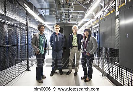 Stock Photo - Business people working in office technology room. Fotosearch