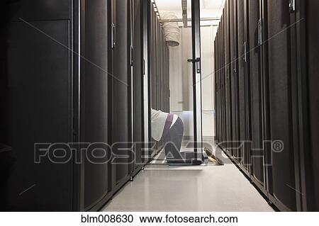 Business person working in office technology room View Large Photo Image Stock Image - Business person working in office technology room. Fotosearch