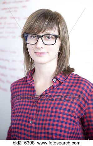 Stock Photo - Businesswoman standing at whiteboard in office. Fotosearch