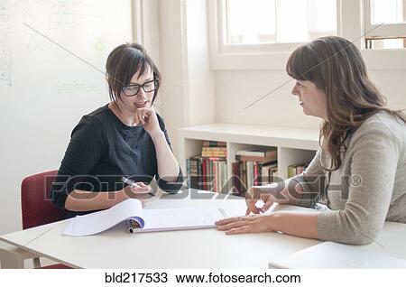 Businesswomen working together in office View Large Photo Image Stock Image - Businesswomen working together in office. Fotosearch