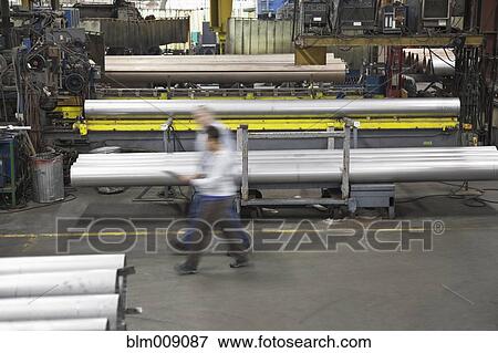 Stock Photo - Busy workers rushing in factory. Fotosearch