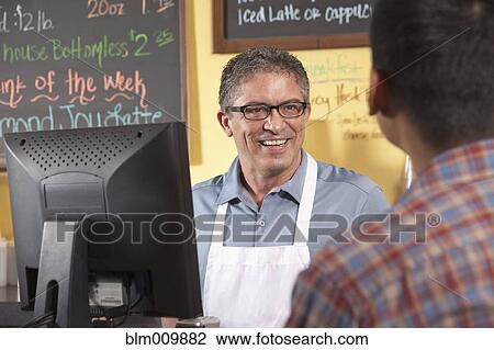 Cafe owner serving customer View Large Photo Image Stock Image - Cafe owner serving customer. Fotosearch
