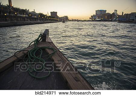 Stock Image - Canoe on urban canal. Fotosearch