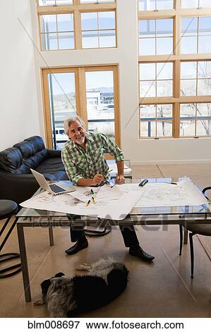 Caucasian architect working with blueprints View Large Photo Image Stock Photo - Caucasian architect working with blueprints. Fotosearch